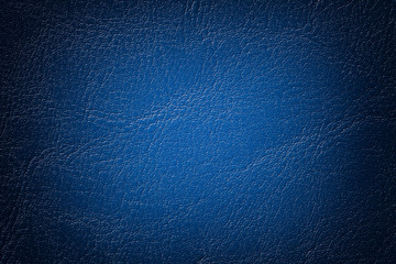 Dark navy blue leather texture background, closeup. Denim cracked backdrop from wrinkle skin