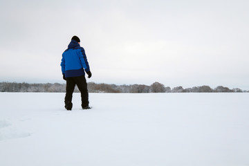 Man walking on snow. Winter.