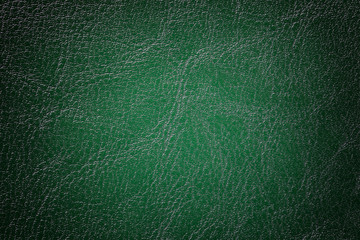Dark green leather texture background, closeup. Emerald cracked backdrop