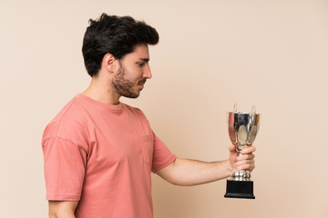 Handsome man holding a trophy