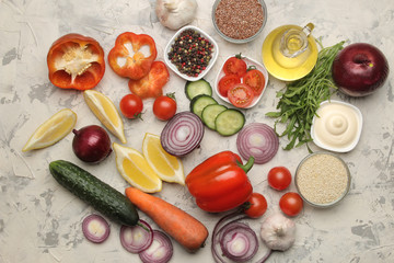 Ingredients for cooking salad. Various vegetables and spices carrots, tomatoes, onions, cucumbers, peppers and arugula on a light background. top view.
