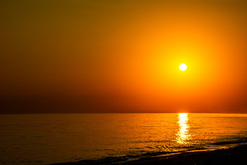 Fototapeta premium Horizontal sunset coastline calm sea with golden sun - Late afternoon on beach waterline with golden direct sunset calm sea ocean - Sun sky sea ocean night time