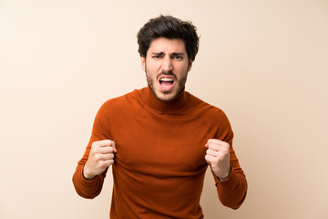 Handsome over isolated wall frustrated by a bad situation