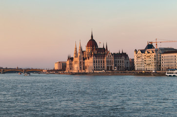 Fototapeta na wymiar The Hungarian Parliament Building on the Danube River in Budapest, Hungary at sunset