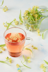 linden blossom and flower tea in a cup for a healthy diet on a white background top view