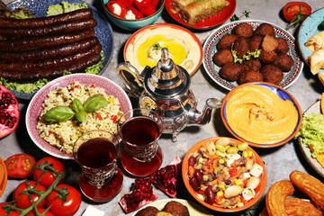 Middle eastern or arabic dishes and assorted meze, concrete rustic background. Falafel. Turkish Dessert Baklava with pistachio. Halal food. Lebanese cuisine