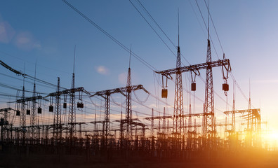 high-voltage power lines at sunset. electricity distribution station .