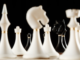 chess pieces on the board on a black background