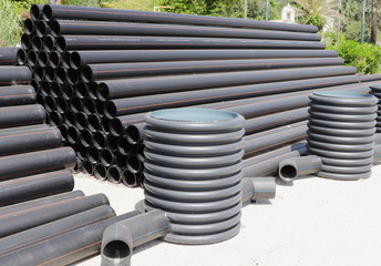 Stack of black  plastic pipes