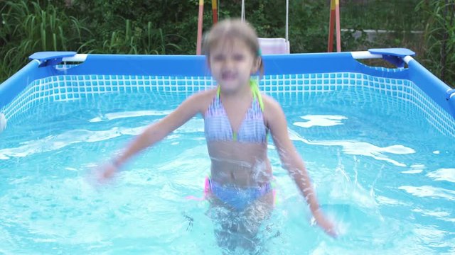 Little Girl Child Learning to Swim in the Pool