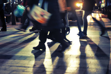 People crossing the street at night