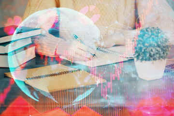 International business hologram over woman's hands taking notes background. Concept of success. Double exposure