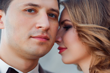Happy newlywed couple. Beautiful bride and groom in a suit.