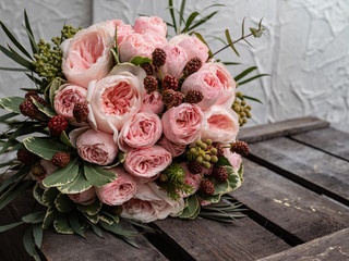 Beautiful wedding bouquet of shrub and peony gently pink roses.