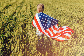 Boy holding American flag. Patriots of America.