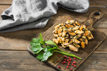 Mussel meat on a wooden Board on a wooden table. Rustic style