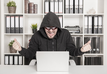 Man hacker using laptop and breaking open password in office