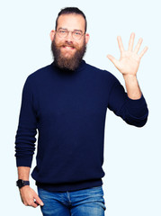 Young blond man wearing glasses and turtleneck sweater showing and pointing up with fingers number five while smiling confident and happy.