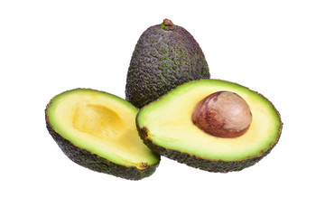 A whole fruit of ripe avocado and cut in half with a big brown bone on a neutral white background.