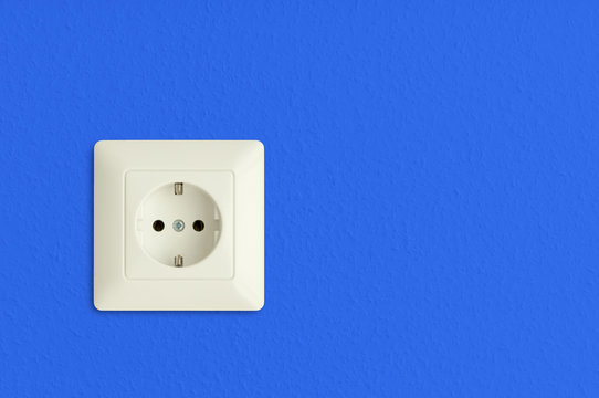 electrical power socket on blue wall, european standard
