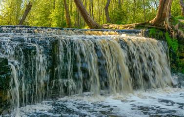Waterfall on the river Sablinka in the village of Ulyanovsk, Leningrad region.