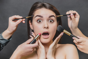 Close up portrait of beauty model girl and make up brushes, lipstick.