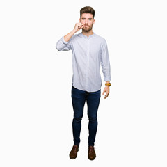 Young handsome man mouth and lips shut as zip with fingers. Secret and silent, taboo talking