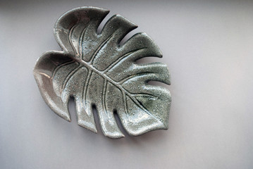 Ceramic leaf palm closeup. background