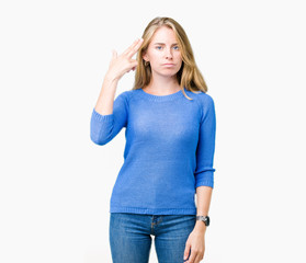 Beautiful young woman wearing blue sweater over isolated background Shooting and killing oneself pointing hand and fingers to head, suicide gesture.