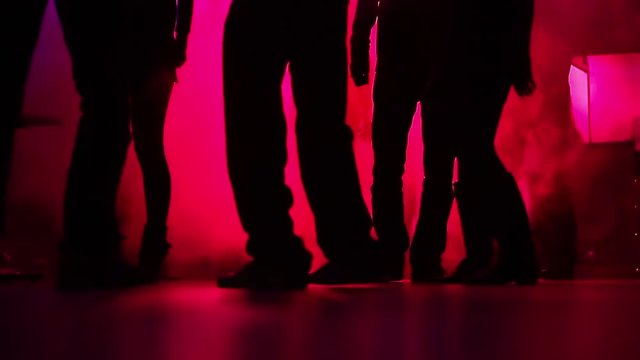 Feet in the dance. Night disco. Young people rest. Super laser show. Dancing people in a nightclub.