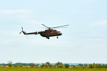 Fototapeta na wymiar Military Russian helicopter over the field