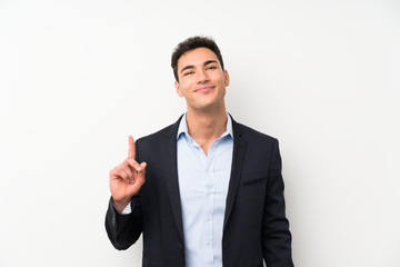 Handsome man over isolated white wall pointing with the index finger a great idea