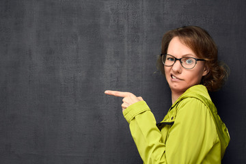 Portrait of discontented girl pointing at something unpleasant