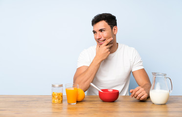Handsome man in having breakfast thinking an idea