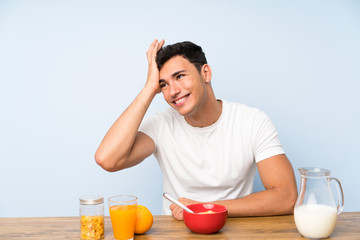 Handsome man in having breakfast laughing