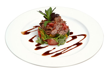 Delicious gourmet food. Meat, sliced tomatoes, basil, with soy sauce on plate on white isolated background. Close-up.
