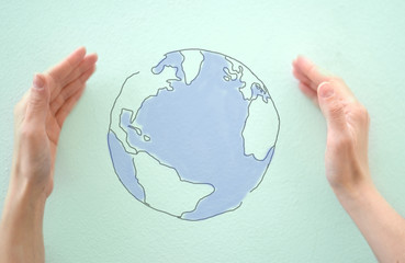 World map protected by female hands, concept of wildlife safeguard