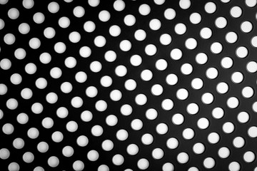 Black speaker lattice background, close-up.