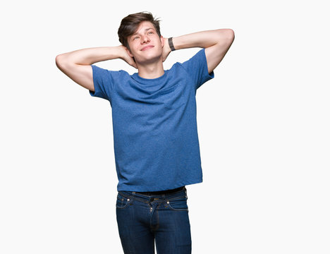 Young handsome man wearing blue t-shirt over isolated background Relaxing and stretching with arms and hands behind head and neck, smiling happy