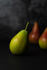 Fototapeta na wymiar Forelle pears on dark background. Selective focus.