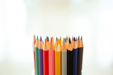 close up color pencils with blurred bokeh background .