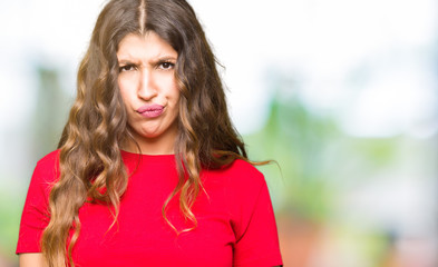 Obraz premium Young beautiful woman wearing casual t-shirt skeptic and nervous, frowning upset because of problem. Negative person.