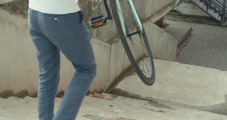 man in carrying his bicycle - Powered by Adobe