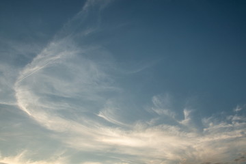 white cirrus cloudy on blue sky in the evening .