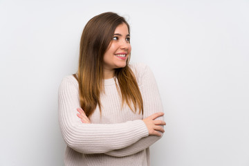 Fototapeta premium Young girl with white sweater standing and looking to the side