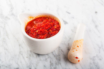 Traditional Maghrebi hot chili pepper sauce paste harissa or adjika. Tunisia and Arabic