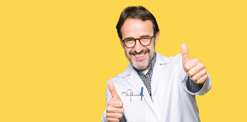 Middle age doctor men wearing medical coat approving doing positive gesture with hand, thumbs up...