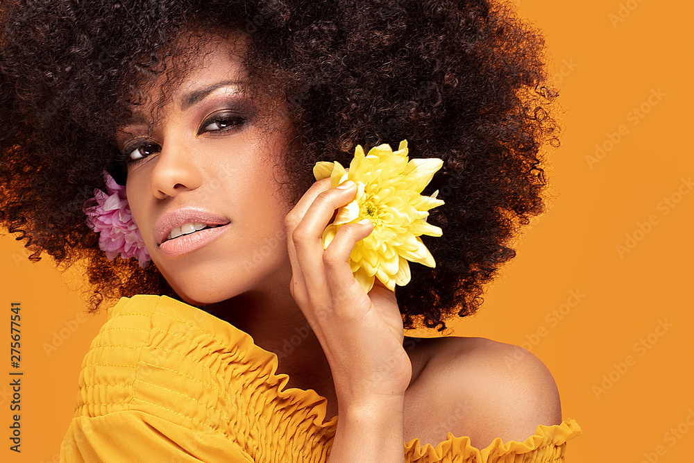 Wall mural Beauty afro woman with fresh flowers.