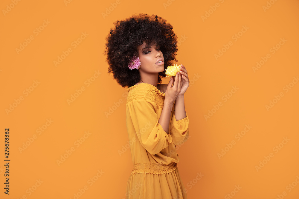 Wall mural beauty afro woman with fresh flowers.