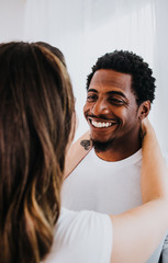 Obraz premium Happy Biracial Couple in Modern White Room